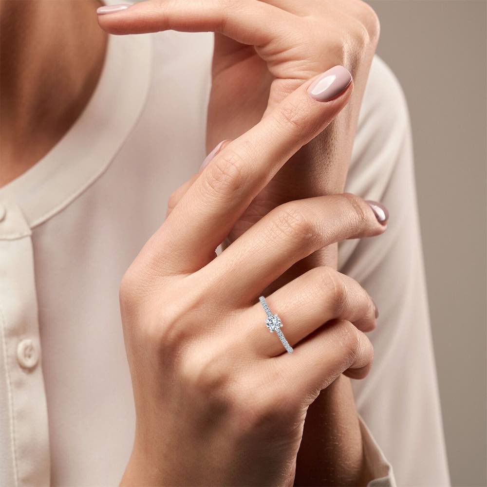 Petite Brilliant Cut Moissanite Engagement Ring hand